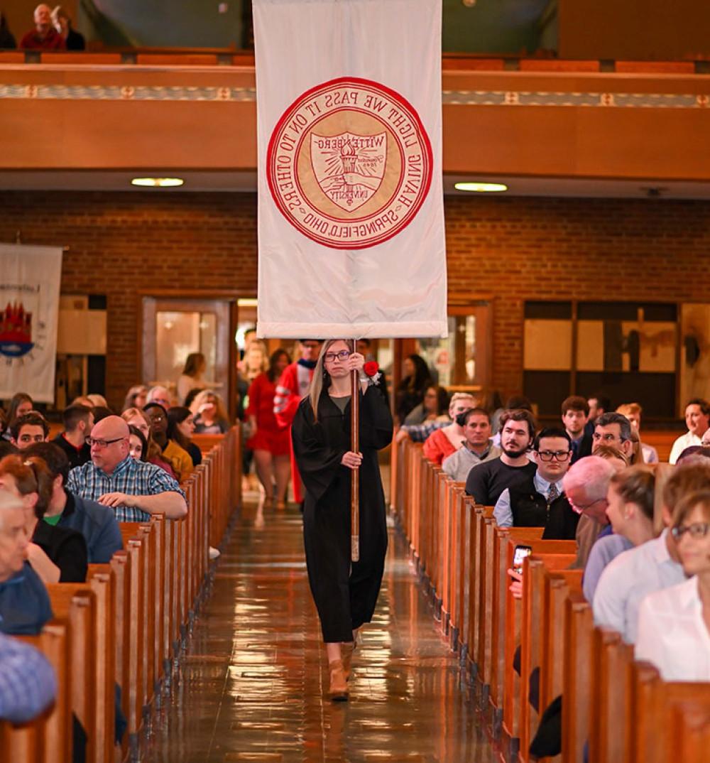 Wittenberg Student with Banner at Honors Convocation